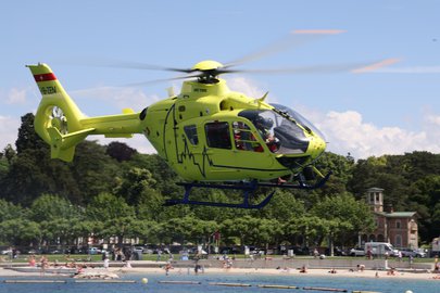  EC 135 flies over a lake