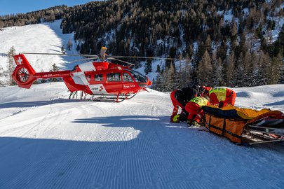 Rega 18 during a rescue operation on the slopes
